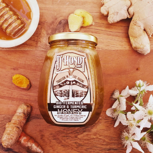 Jar of Bio-Fermented Turmeric & Ginger Honey with a rich golden color, promoting immune and digestive health with bio-fermented turmeric and ginger.